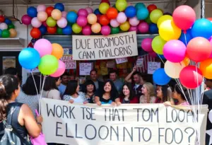 Community members gather at a balloon shop showing support for an Iranian woman detained by ICE.