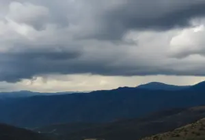 Dark clouds over Southern California mountains indicating rainfall