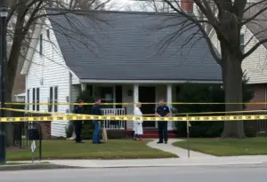 Police officers investigating a residential area for a missing person case.